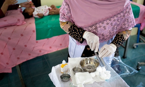 The midwife at the clinic in Pattani prepares the tools to cut eight-week-old Amiyah. Photograph: Lillian Suwanrumpha